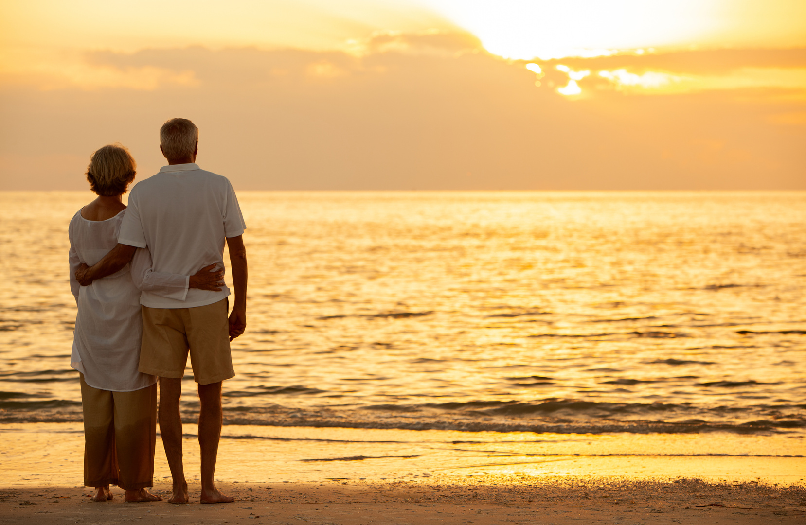 Senior Couple Watching the Sunset at the Beach
